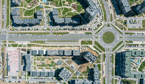 aerial top view of urban apartment houses and streets with roundabout intersection in a residential area