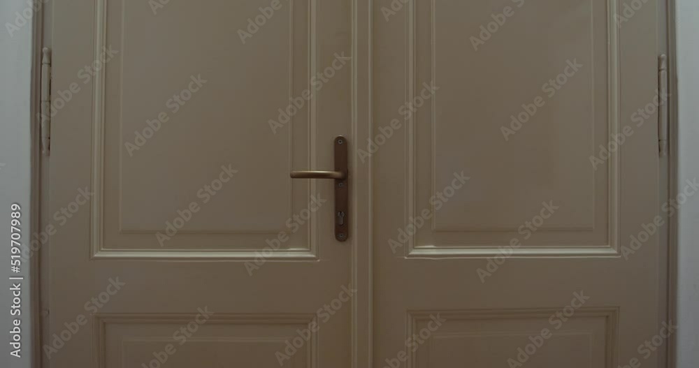 Keys falling down from keyhole of banging door, horror or fear concept, slider closeup view Keys falling down from keyhole of banging door, horror or fear concept, slider closeup view