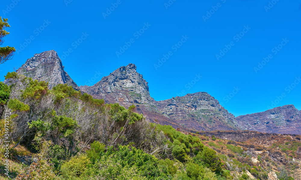 Landscape, mountain view and blue sky of Twelve Apostles with copy space in remote countryside hiking forest. Scenery of famous landmark in an environmental nature reserve in Cape Town, South Africa