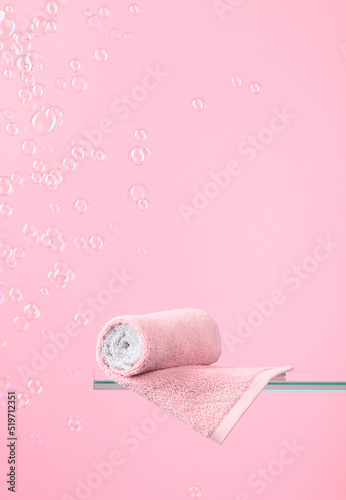 Towel on a pink background with bubbles. © Igor Normann