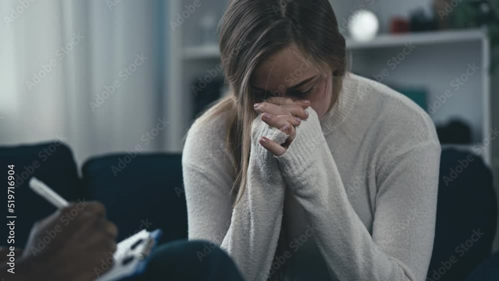 Unhappy young woman with injured face crying at therapy session, depression Unhappy young woman with injured face crying at therapy session, depression