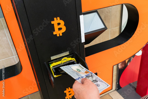 Atm bitcoin cryptocurrency machine. Woman withdraw american dollar bill cash. Usd hundred money payment on virtual crypto currency btc wallet. Bitcoin BTC ATM Cash Machine.