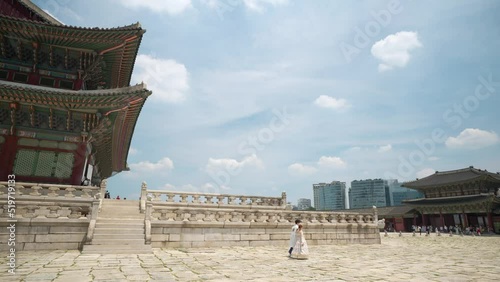 Gyeongbokgung Palace - Korean Couple Wearing Traditional Hanbok Royal Costumes Travel Inside Geunjeongjeon Hall on Summer day - copy space photo