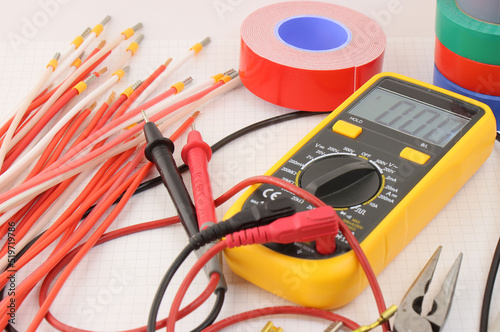 Multimeter and tools for installing an electrical control panel in close-up on. 