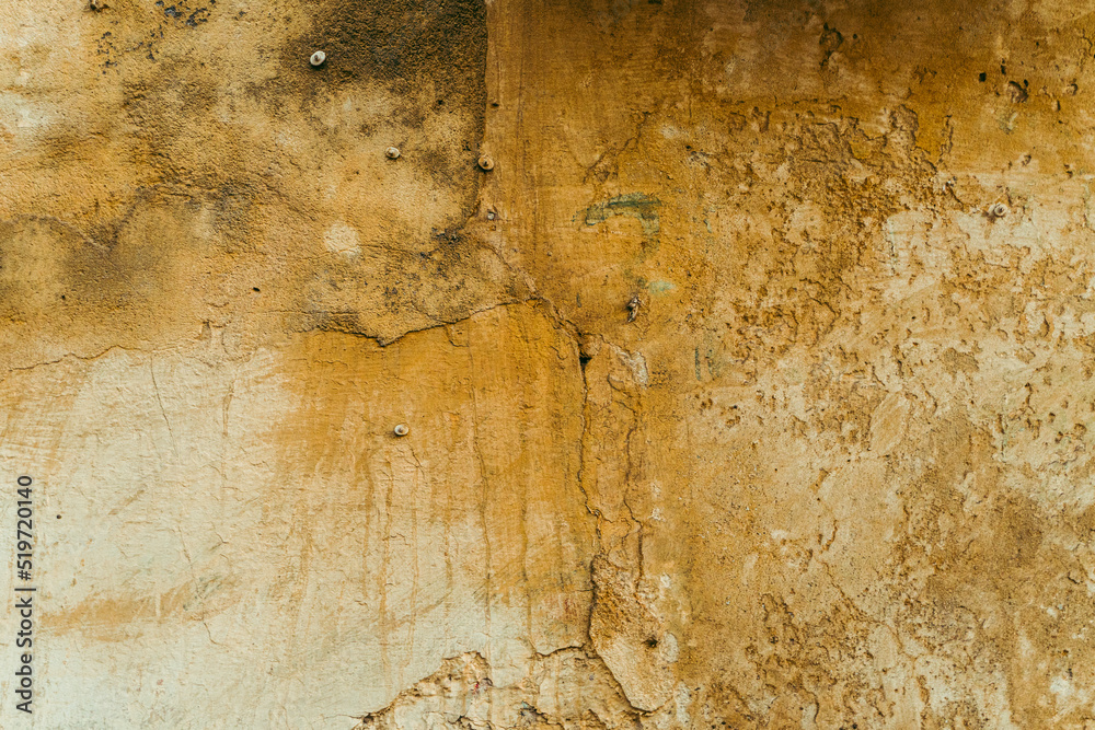 Destroyed cracked wall background, brown light texture, paint streaks.