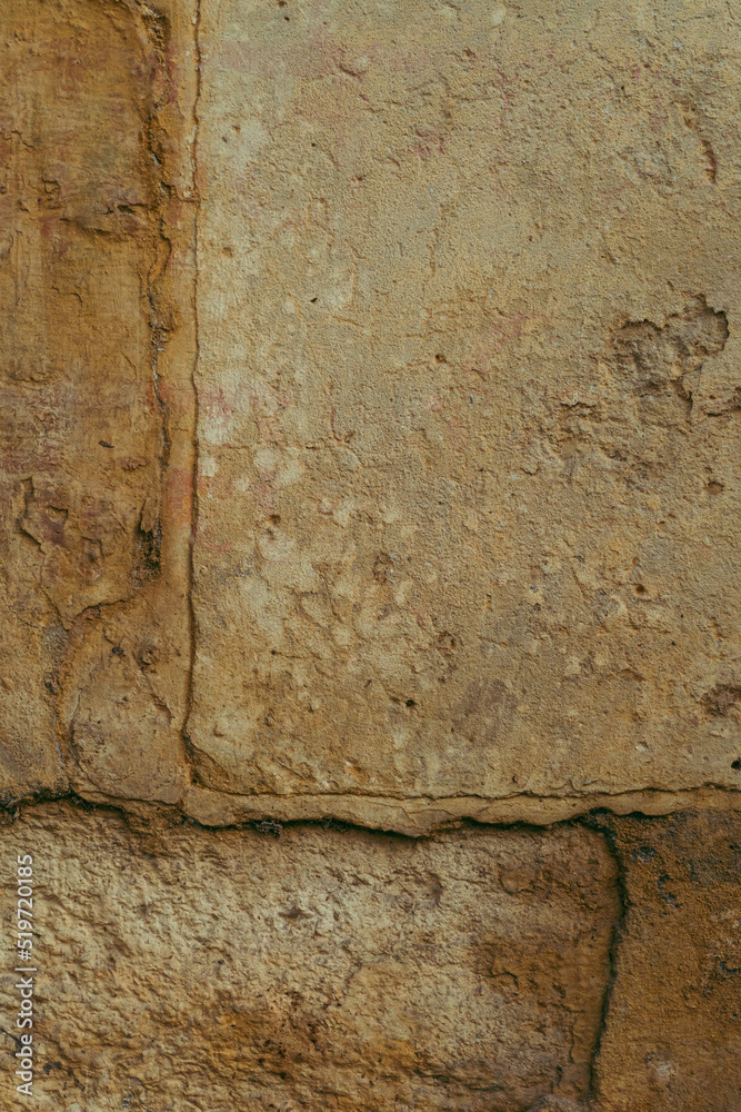 Destroyed cracked wall background, brown light texture, paint streaks.