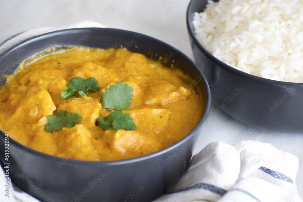 Chicken korma in a bowl. Traditional Indian curry with rice on the table. Chicken korma in a bowl. Traditional Indian curry with rice on the table.