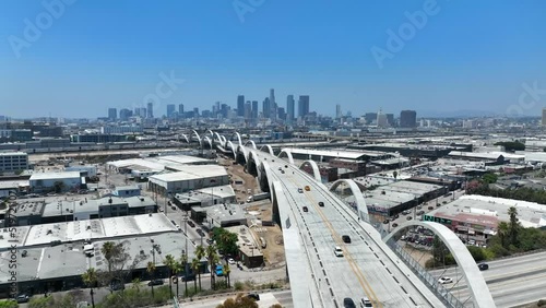 Aerial view of the 6th Street Viaduct bridge passing through to downtown Los Angeles over LA river in California on a sunny day. photo