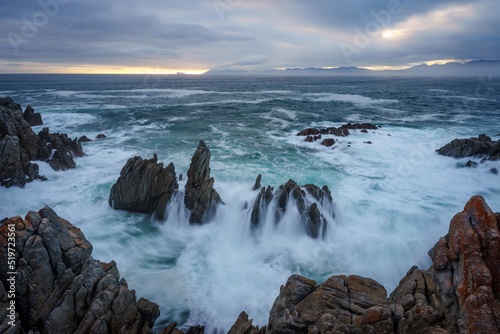 The beautiful coastline at De Kelders with a view across Walker Bay towards Hermanus, Overberg, Western Cape, South Africa. photo