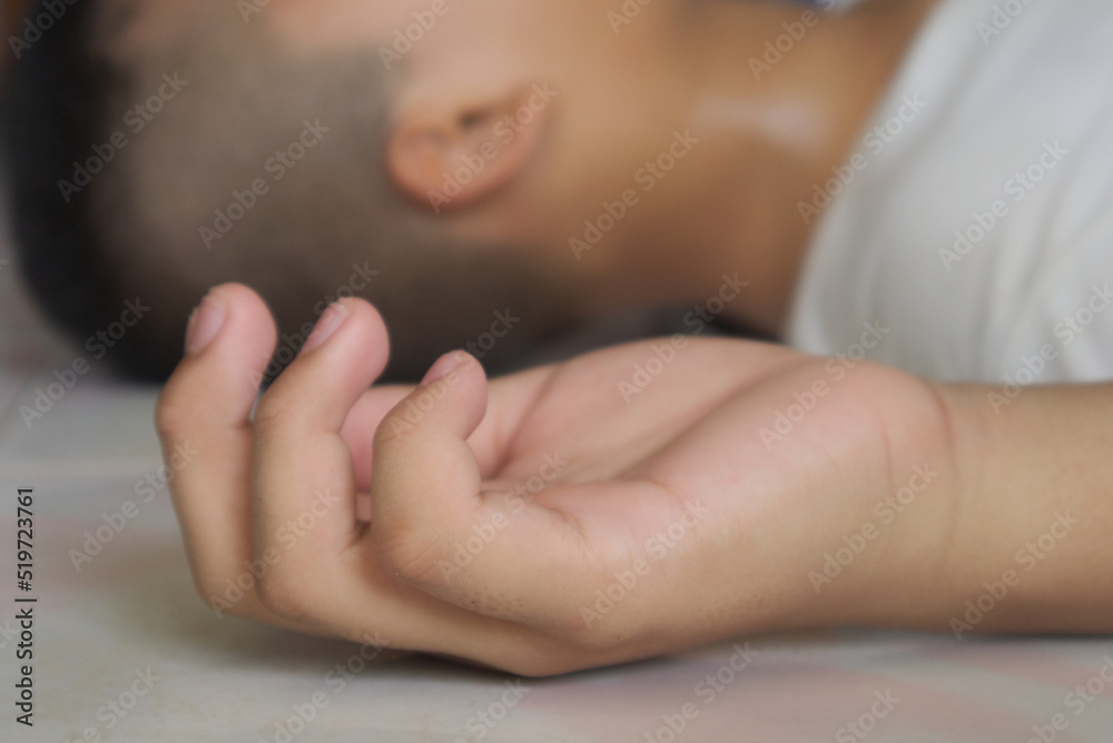 Close up hand of child unconscious in room