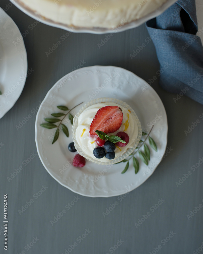 Pastries decorated with berries on a wooden background Pastries decorated with berries on a wooden background