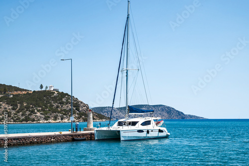 Sailing catamaran moored at sea pier on Mediterranean sea