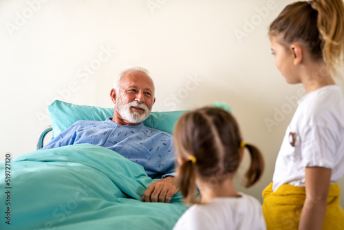 Happy grandfather is recovering from the coronavirus is visited by his grandchildren