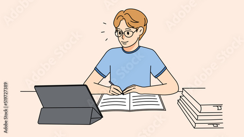 Guy in glasses study online on pad