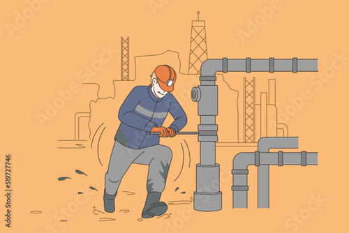 Male worker repair pipe at oil production site 