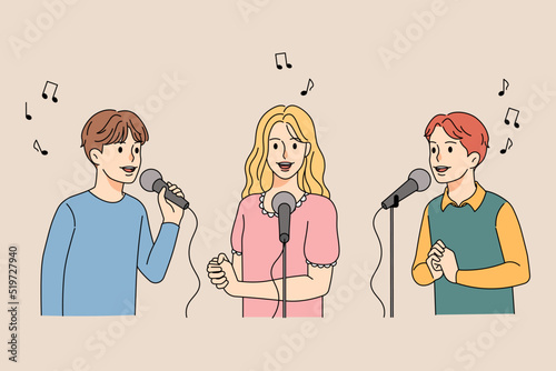 Happy children singing in microphones 