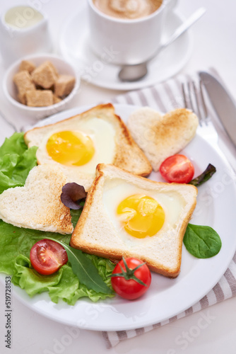 Fried Egg on Toast Bread and cup of fresh hot coffee on light grey background