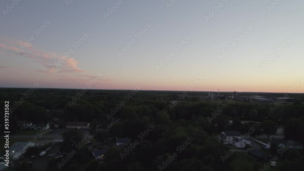 Frontal tracking during dusk with drone in a small town near the forest Frontal tracking during dusk with drone in a small town near the forest