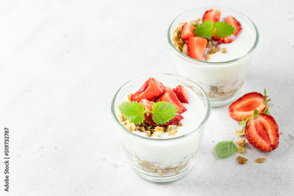 Strawberry granola greek yogurt parfait in glasses. Top view, copy space,flat lay. Strawberry granola greek yogurt parfait in glasses. Top view, copy space,flat lay.