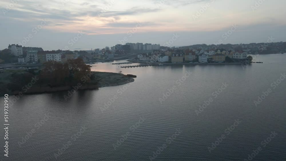Aerial view flying over the water getting close to the beautiful island Ekholmen in the naval city of Karlskrona, Sweden with typical swedish houses around. Aerial view flying over the water getting close to the beautiful island Ekholmen in the naval city of Karlskrona, Sweden with typical swedish houses around.