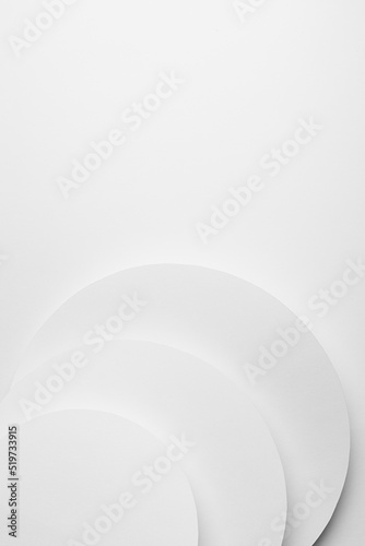 White paper round surfaces fly as soft light abstract geometric background with copy space in gentle elegant minimal style for business card, poster, flyer, text, top view, vertical.