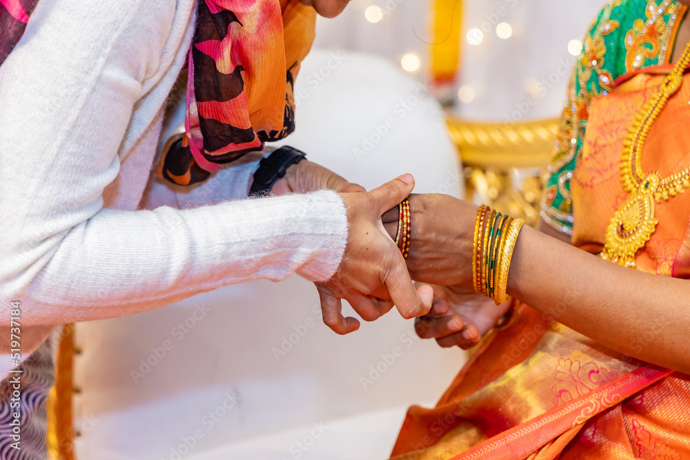 South Indian Tamil bride's wearing her traditional bangles hands close up