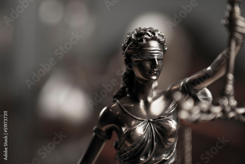 Law and justice concept. Justice symbol - Themis sculpture on gray background.