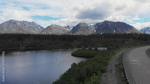 4K Drone Video of Mountain Peaks and Granite Creek near Denali National Park in Alaska on Sunny Summer Day photo