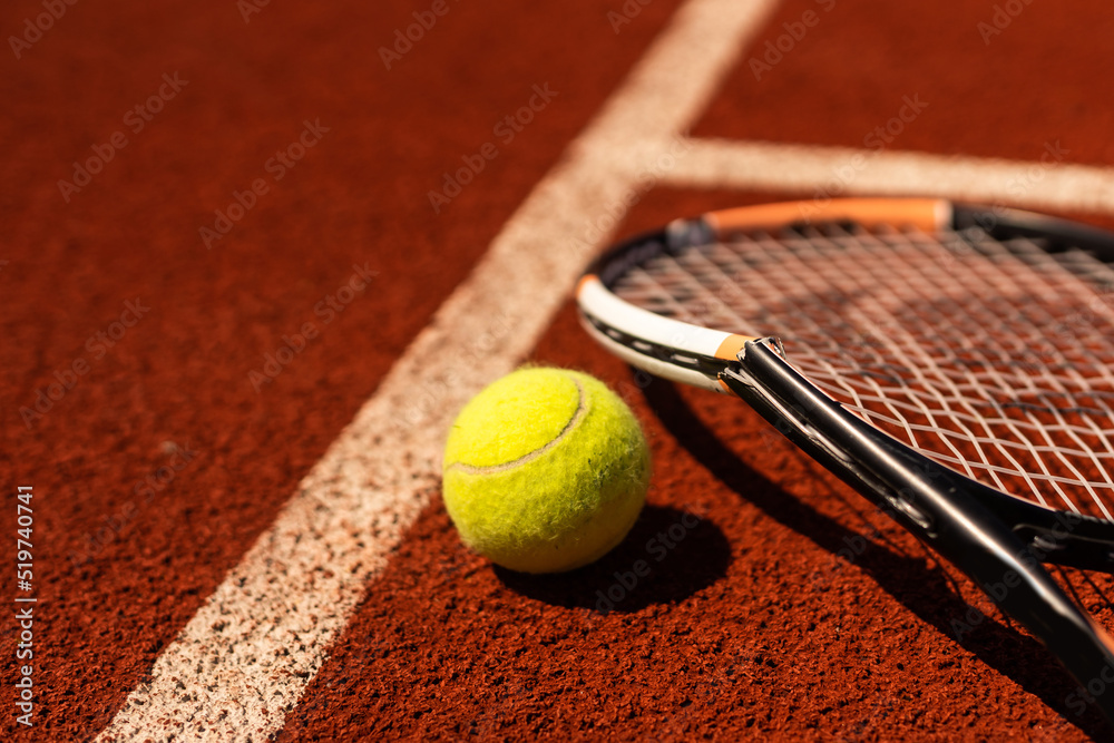 Broken tennis racket on clay tennis court