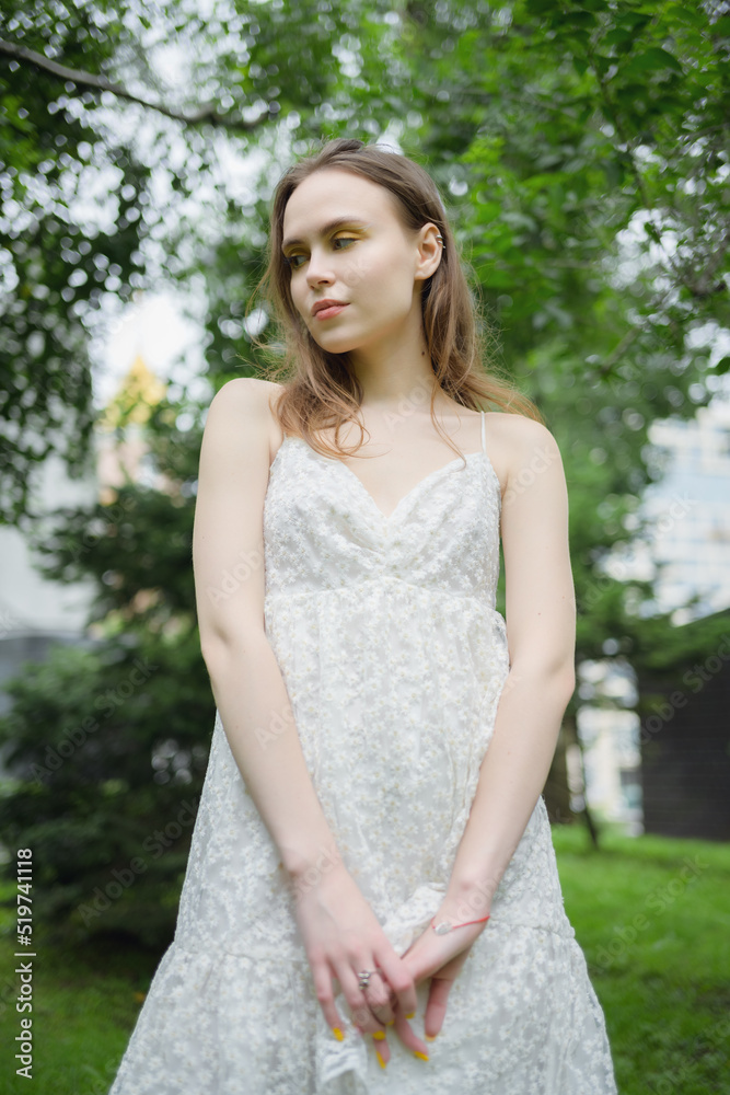 City portrait of beautiful young woman in white dress. City portrait of beautiful young woman in white dress.