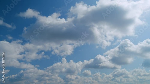 Fluffy curly rolling cloud in windy spring weather. White clouds background. photo