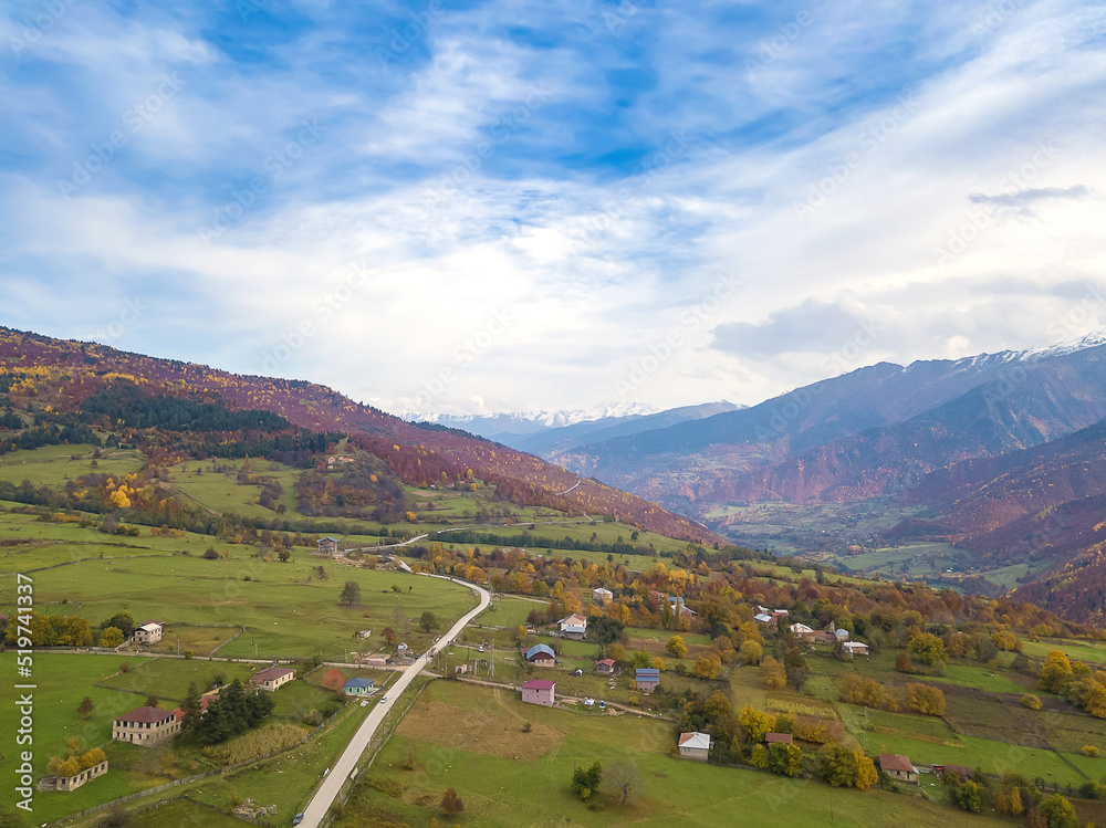 Small mountain village of Svaneti on an autumn day, a view from a drone. Mountain landscape in Georgia. Nature background, aerial view. Shooting from a drone.