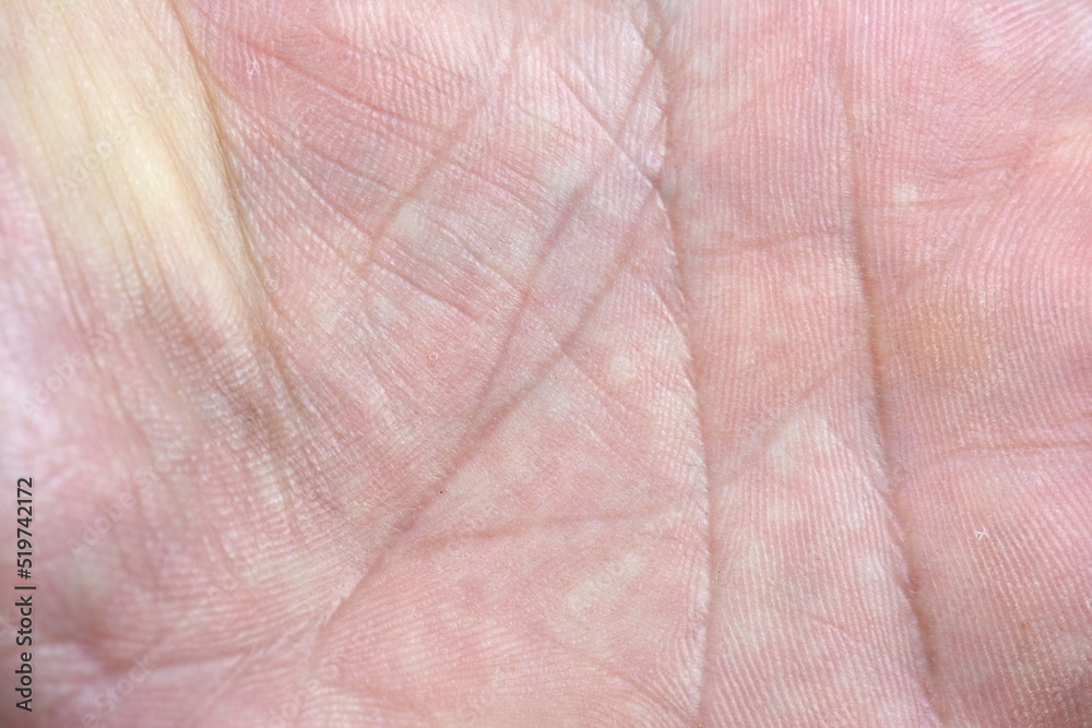 Close up of human hand palm with visible lines. Skin texture background. Background from the lines on the hand. Macro. Human skin, closeup of the inner surface of a male hand.