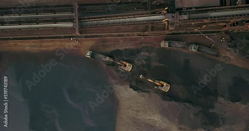 Bird's Eye View Of Excavators Loading Coal Into Large Dump Trucks At Paradip Port In Odisha, India - drone shot photo