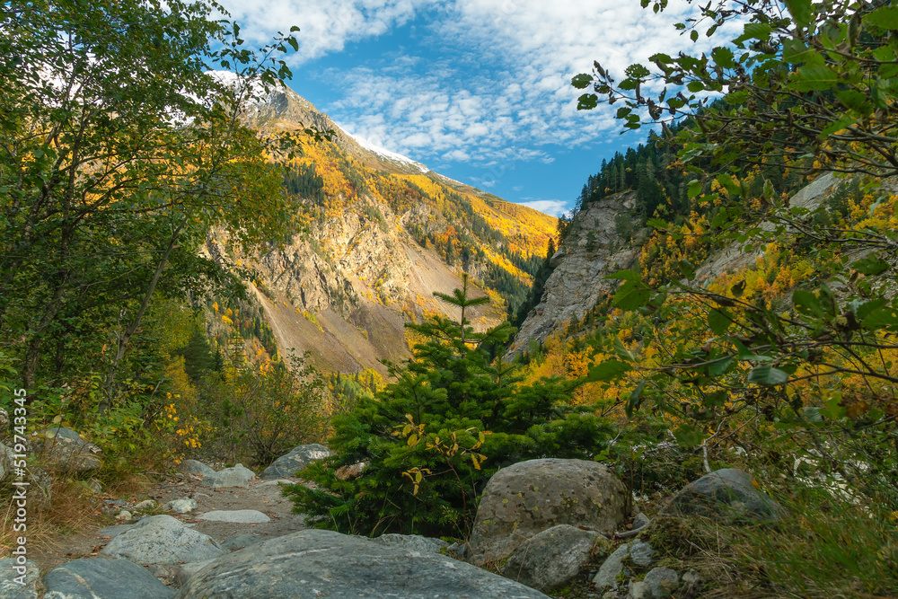 Beautiful landscape of the Caucasus mountains, a trail in a mountain gorge on an autumn sunny day, Georgia Beautiful landscape of the Caucasus mountains, a trail in a mountain gorge on an autumn sunny day, Georgia