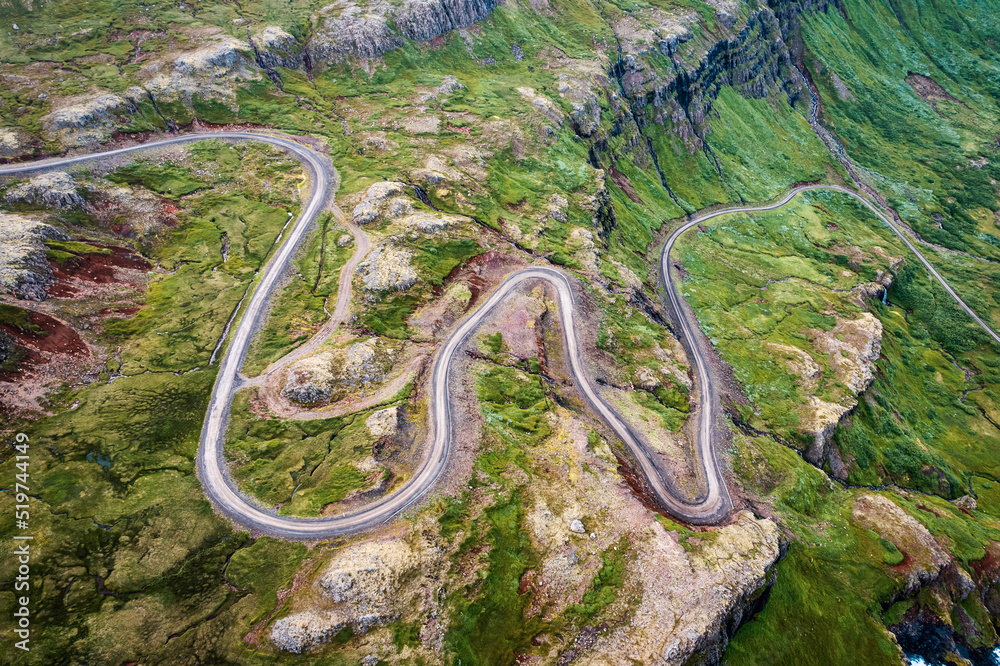 Winding gravel road through fjord of the valley in Icelandic highlands