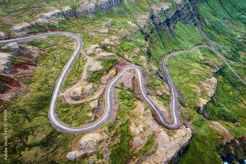 Winding gravel road through fjord of the valley in Icelandic highlands