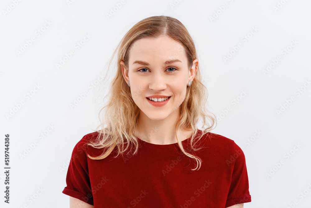 Young emotional woman. Close up portrait of young blonde woman 20s, wearing casual red t shirt. Indoor studio shot on white background. Human emotions, facial expression concept Young emotional woman. Close up portrait of young blonde woman 20s, wearing casual red t shirt. Indoor studio shot on white background. Human emotions, facial expression concept