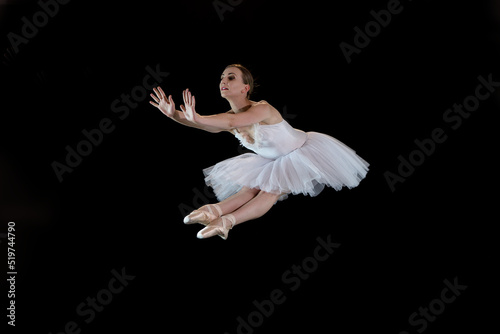Ballet dancer on a black background. The dancer in a dance. Ballet pose. Dancer in a jump