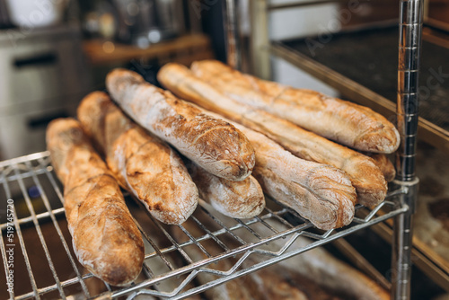 Fresh tasty Baguettes on bakery shelves. Concept of french delicious food