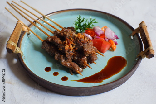 a plate of beef satay named sate maranggi in Bahasa photo