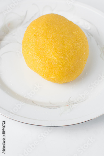 Eba on a white plate, Nigerian garri, yellow garri on a white plate photo