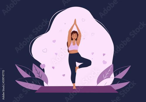beautiful woman practicing yoga in tree pose 
