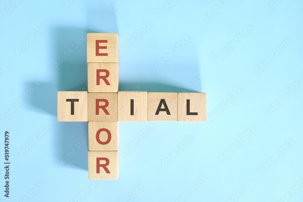 Trial and error approach concept. Wooden block crossword puzzle flat lay in blue background. Trial and error approach concept. Wooden block crossword puzzle flat lay in blue background.