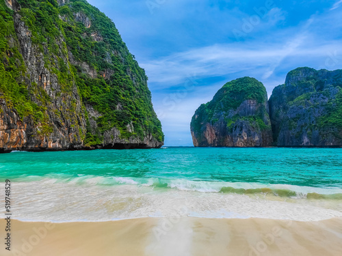 Maya bay beach with turqoise water and waves with no people in a paraside island Koh Phi Phi Le. Located in Andaman sea in Thailand