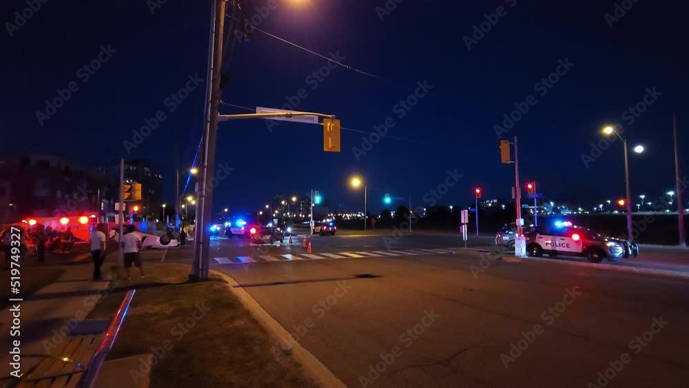People watching emergency services clearing wreckage after a multi car accident