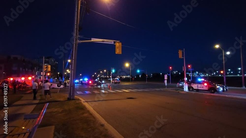People watching emergency services clearing wreckage after a multi car accident