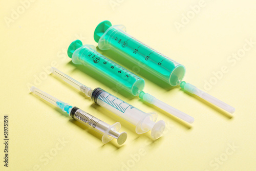 Top view of syringes in a row for medical injection on colorful background with copy space. Health and vaccination concept