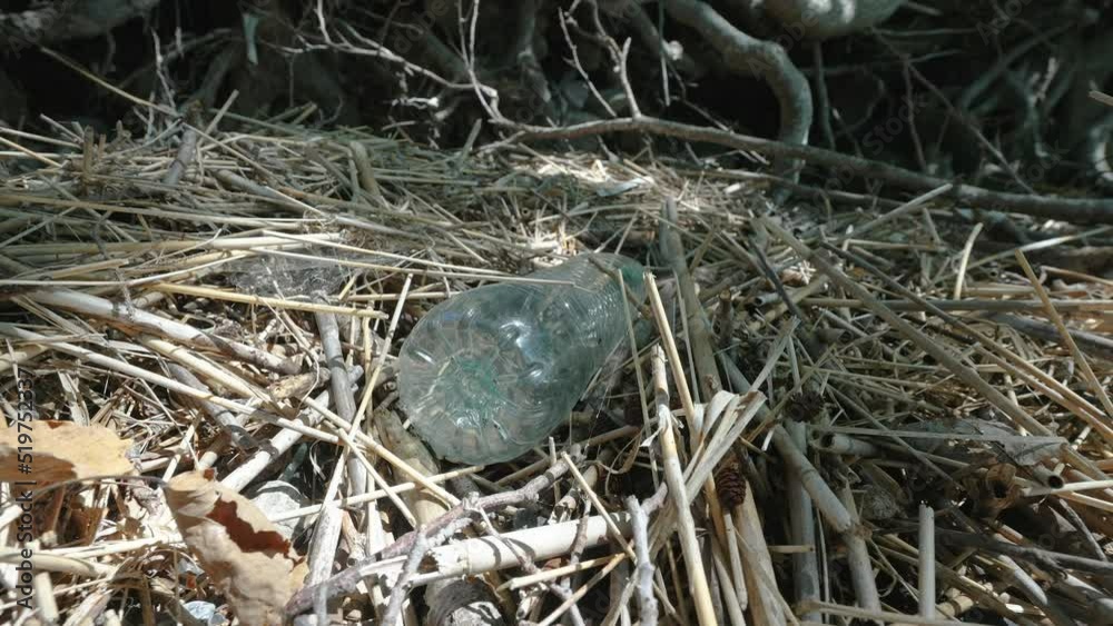 Closer look of the plastic bottle on the ground thrown in the environment as waste in Estonia