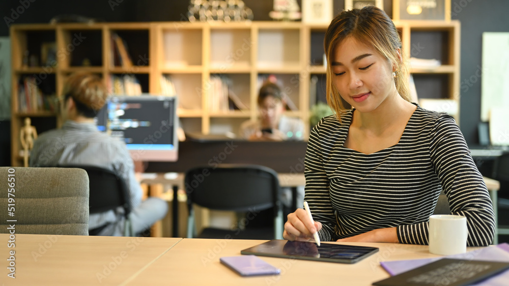Young programmers or software developers using digital tablet, working in modern office Young programmers or software developers using digital tablet, working in modern office